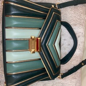 Gently used Michael Kors bag. Can be a shoulder bag or clutch. Expandable.